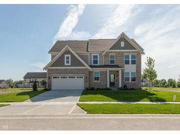 Two-story brick home featuring an attached two-car garage and a well-manicured front yard at 1101 Knoll Ct, Greenwood, IN 46143