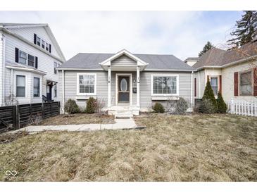 Charming single-story home featuring a welcoming front porch and well-maintained landscaping at 1208 W 8Th St, Anderson, IN 46016