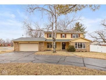 Charming two-story home with a large front yard and attached two-car garage at 2830 Moller Rd, Indianapolis, IN 46224