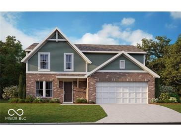 Charming two-story home featuring a brick and siding exterior with a two-car garage and well-manicured lawn at 335 Atlas Dr, Lebanon, IN 46052
