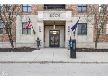 Stylish Hudson building facade with American and Indiana state flags flanking the main entrance at 355 E Ohio E St # 206, Indianapolis, IN 46204