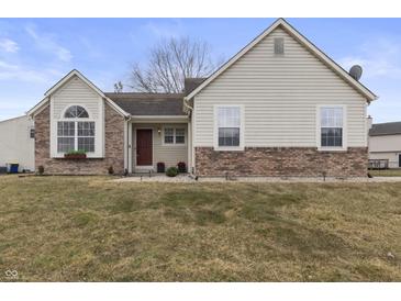 Charming home with a combination of siding and brickwork and well-maintained lawn at 10441 Alexia Dr, Indianapolis, IN 46236