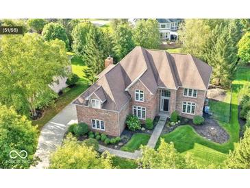 Stunning aerial view of a brick home surrounded by lush landscaping and mature trees at 13133 Brooks Landing Pl, Carmel, IN 46033
