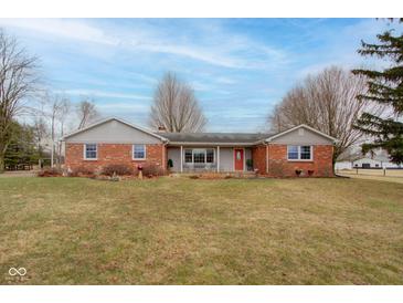 Charming brick ranch-style home features an inviting entrance and a well-manicured front lawn at 15247 E 191St St, Noblesville, IN 46060