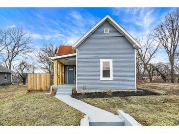 Charming home featuring light blue siding, a welcoming front porch, and a well-maintained front yard at 1842 Tallman Ave, Indianapolis, IN 46218