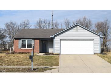 Charming single-Gathering home featuring a brick and siding facade, an attached two-car garage, and a well-maintained front lawn at 400 Lockerbie Ln, Pittsboro, IN 46167