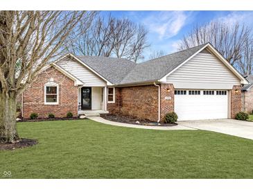 Charming brick home featuring a two-car garage, well-maintained lawn and a walkway to the front door at 4019 Santa Clara Dr, Greenwood, IN 46142