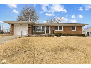 Charming brick ranch home featuring a well-maintained lawn and attached single-car garage at 488 N 24Th Ave, Beech Grove, IN 46107