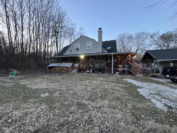 A charming two-story home with a covered porch and spacious backyard with plenty of room for activities at 5202 Riverview Dr, Indianapolis, IN 46208