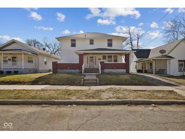 Charming two-story home featuring a welcoming front porch and classic architectural details at 1023 W 7Th St, Anderson, IN 46016