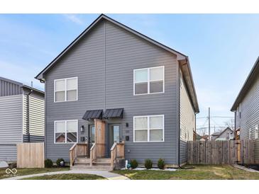 Charming two-story duplex with gray siding, a walkway, and well-manicured lawns at 139 Mckim Ave, Indianapolis, IN 46201