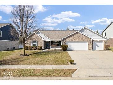 Charming brick home with a well-manicured lawn and a two-car garage at 4704 Blue Marlin Way, Indianapolis, IN 46239