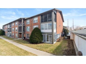 Brick apartment building with sunrooms, balconies, and well-maintained landscaping at 5034 Allisonville Rd # A, Indianapolis, IN 46205
