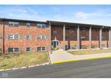 Charming brick apartment building with well-maintained landscaping and classic architectural details at 5034 Allisonville Rd # A, Indianapolis, IN 46205