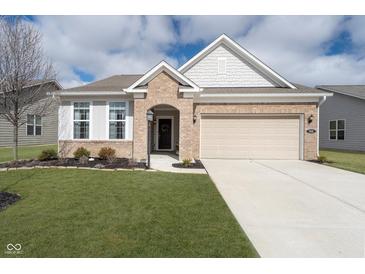 Charming brick home featuring an attached two-car garage and a well-manicured front lawn at 568 Harstad Blvd, Westfield, IN 46074