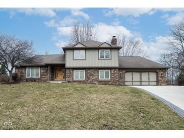 Charming two-story brick home with a well-manicured lawn and attached two car garage at 5704 Springhollow Ct, Avon, IN 46123