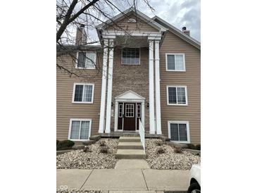 Charming three-story exterior with stone and tan facade, and large columns framing the entryway at 6526 Jade Stream Ct # 309, Indianapolis, IN 46237
