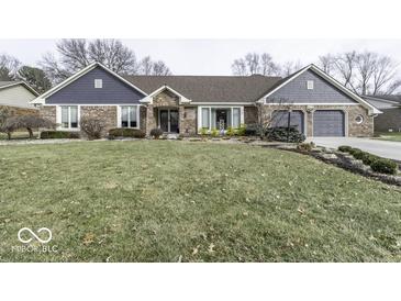 Charming brick home with a well-maintained front yard and attached two-car garage at 8901 Rocky Ridge Rd, Indianapolis, IN 46217