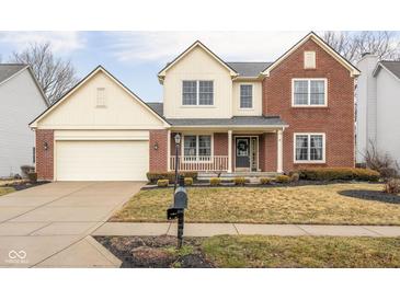 Charming two-story home with a brick and siding exterior, attached garage, and well-manicured front lawn at 11866 Weathered Edge Dr, Fishers, IN 46037