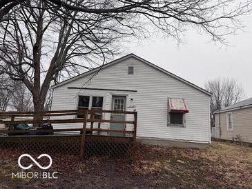 Cozy single-story home with a welcoming deck, mature tree, and a classic, neutral-toned exterior at 1900 E Purdue Rd, Muncie, IN 47303