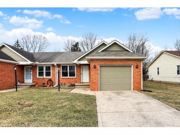 Charming brick home featuring an attached garage and a well-maintained front yard at 2184 Galaxy Dr, Franklin, IN 46131