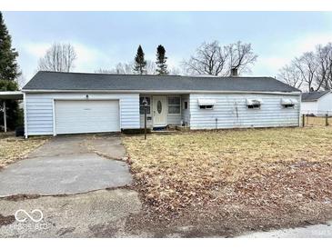 A single-story home with a one-car garage and a small front yard in need of maintenance at 2513 W 10Th St, Muncie, IN 47302