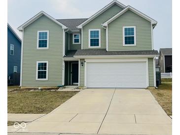 Charming two-story home with a two-car garage and manicured lawn, perfect for suburban living at 476 Haywood Dr, Greenfield, IN 46140
