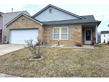 Charming brick home featuring a two-car garage and inviting front porch at 6896 Maywood Cir, Avon, IN 46123