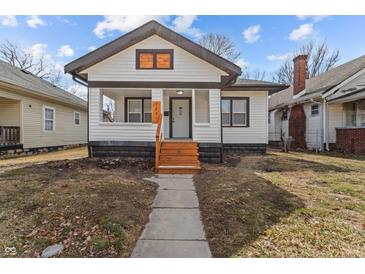 Charming bungalow featuring fresh exterior paint and a tidy front yard at 729 W 32Nd St, Indianapolis, IN 46208