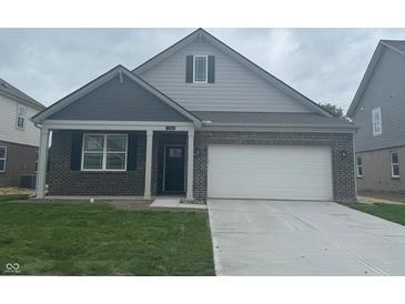 Charming single-Gathering home featuring a two-car garage and a welcoming, covered front porch at 1366 Foxtail Ln, Greenwood, IN 46143