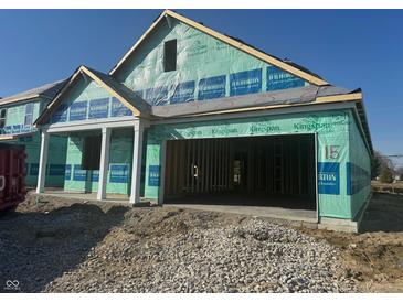 New construction home with a large two-car garage and a covered front porch at 1366 Foxtail Ln, Greenwood, IN 46143