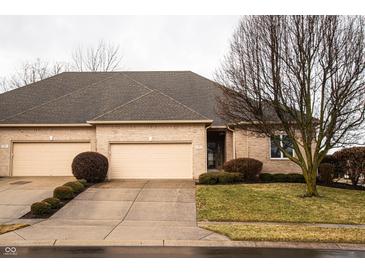 Charming brick townhouse with two-car garage and manicured landscaping at 1502 Heron Ridge Blvd, Greenwood, IN 46143