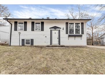 Charming two-story home with a white exterior, black shutters, and a well-manicured lawn at 4249 Dubarry Rd, Indianapolis, IN 46226