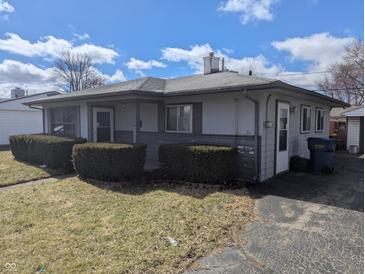 Charming single story home with mature landscaping and inviting entrance, under a bright sky at 5250 N Richardt Ave, Indianapolis, IN 46226