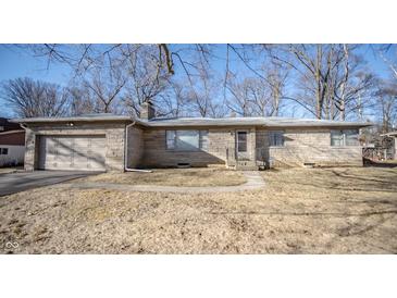 Charming single-story home featuring stone exterior, attached garage, and a well-maintained front yard at 5502 Radnor Rd, Indianapolis, IN 46226