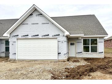 New home exterior features a white garage door, white front door, gray shingle roof and large window at 614 Silver Fox Ct, Indianapolis, IN 46217