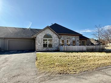 Charming single-story home featuring brick facade, attached garage, and well-maintained front yard at 7437 Vineyard Dr, Fishers, IN 46038