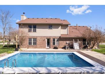 Inviting backyard features a sparkling in-ground pool, perfect for outdoor enjoyment and relaxation at 8333 Hunters Meadow Ct, Indianapolis, IN 46259