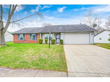 Charming single-story home featuring a well-maintained front yard and attached two car garage at 11363 Kristen Ln, Indianapolis, IN 46235