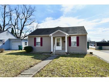 Charming single-story home featuring gray siding, a gray roof, and well-maintained landscaping at 1507 Park Dr, Lebanon, IN 46052
