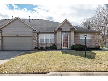 Charming brick front exterior with attached garage and well-manicured lawn in residential neighborhood at 18357 Piers End Dr, Noblesville, IN 46062