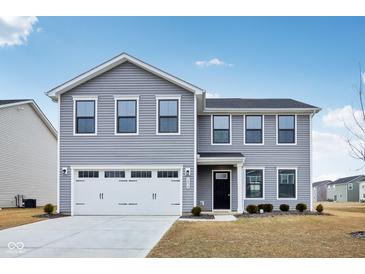 Charming two-story home with gray siding, a two-car garage, and manicured front yard at 1854 Cascades Dr, Greenfield, IN 46140
