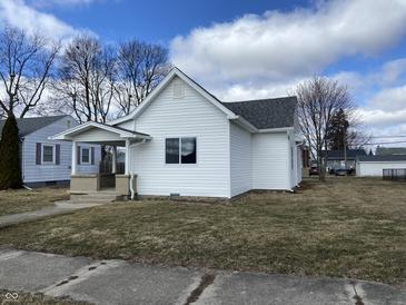 Charming single-story home with white siding, a cozy front porch, and well-maintained landscaping at 2712 S A St, Elwood, IN 46036