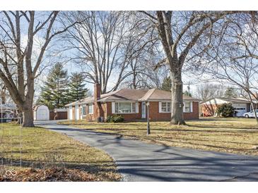 Charming single-story brick home with a large front yard and a long driveway at 4808 N Tuxedo St, Indianapolis, IN 46205