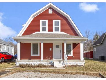 Charming two-story home with red siding, white trim, and a cozy covered front porch at 5334 E Burgess Ave, Indianapolis, IN 46219