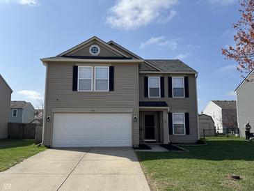 Charming two-story home featuring a two-car garage, gray siding, and manicured lawn on a sunny day at 785 Country Gate Dr, New Whiteland, IN 46184