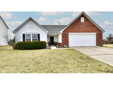 Charming single-Gathering home featuring a mix of white siding and brick with an attached two-car garage at 1055 Berrywood Dr, Greenwood, IN 46143