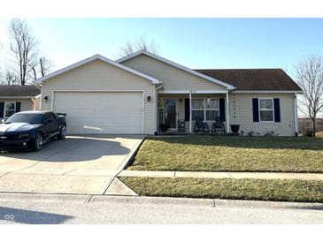 Charming single-story home featuring a manicured lawn and attached two-car garage at 1217 Meadowood Dr, Danville, IN 46122