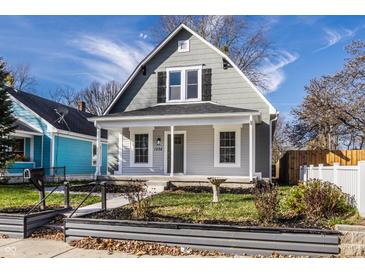 Charming gray two-story home with a welcoming front porch and well-maintained landscaping at 1224 N Olney St, Indianapolis, IN 46201