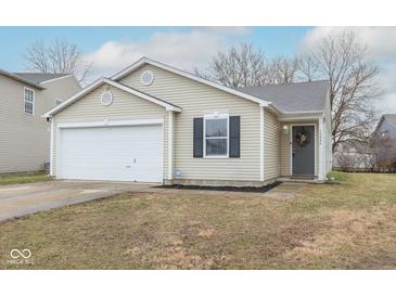 Charming single-story home with vinyl siding, a well-manicured lawn, and an attached one car garage at 13446 N Carwood Ct, Camby, IN 46113